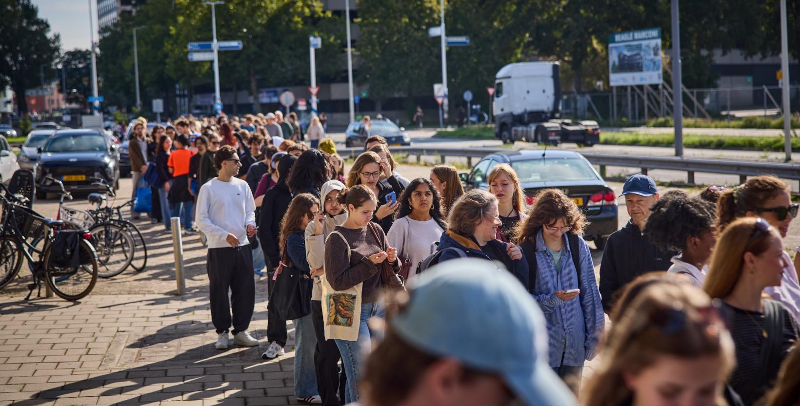 Lange rij bezoekers op de stoep bij de Citrusveiling in Rotterdam.